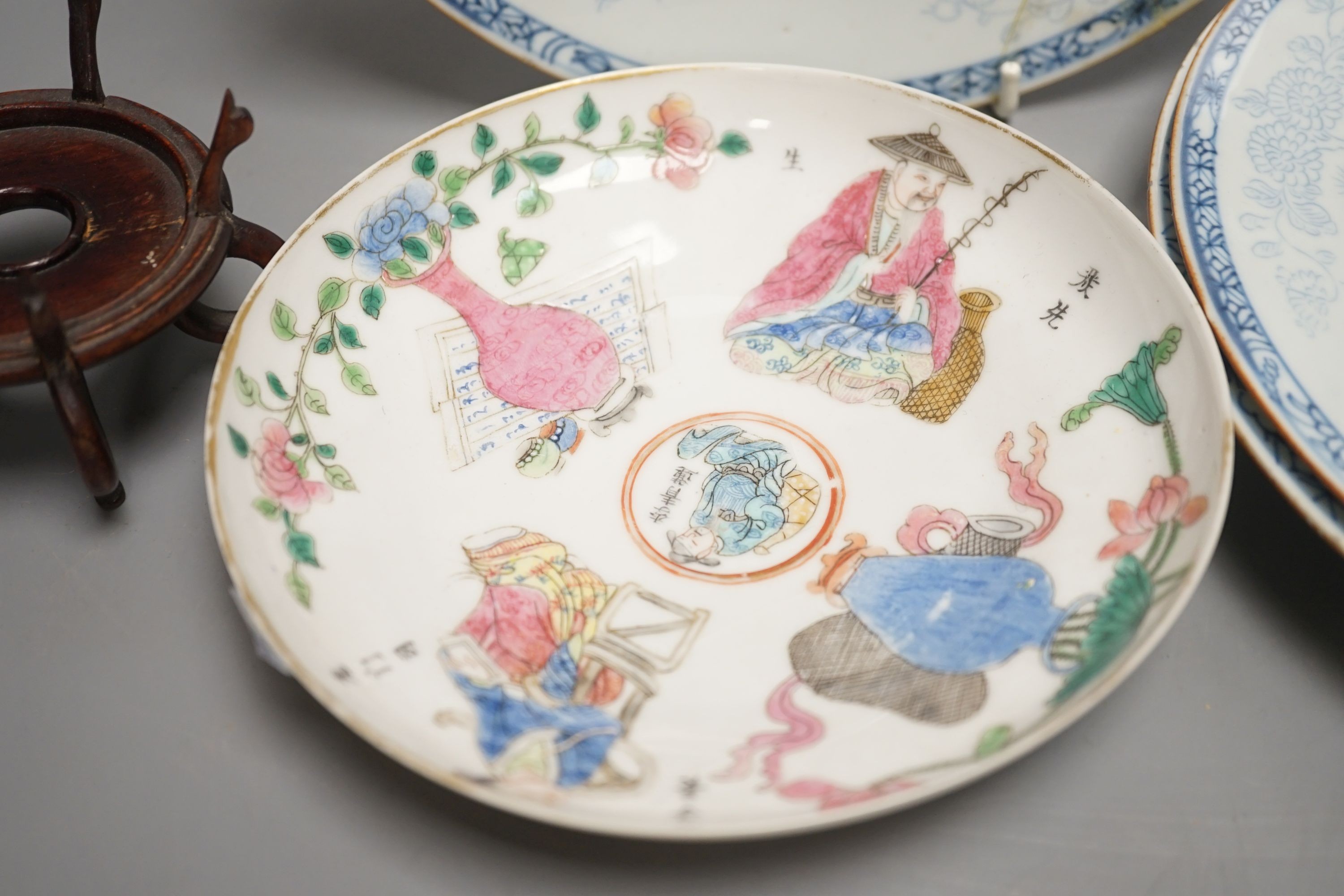 A 19th century Chinese famille rose bowl and saucer, a blue and white tea bowl on stand, a hardstone carving and three 18th century blue and white plates